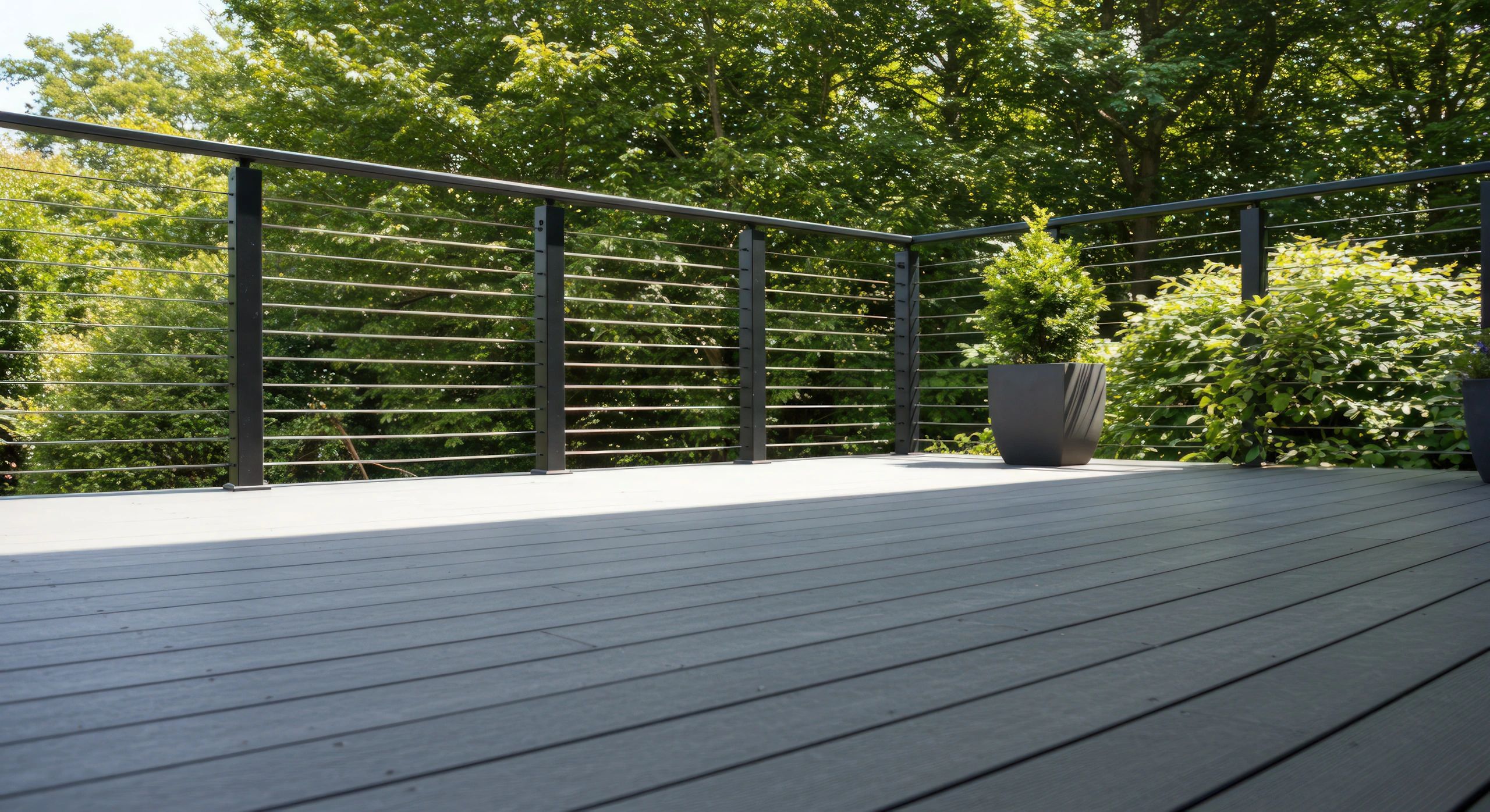 Beautiful advanced PVC decking in a shade of grey with black cable railings. A timeless pair.
