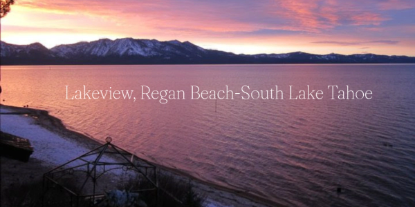 Sunset over Lakeview, Regan Beach at South Lake Tahoe with snowy mountains.
