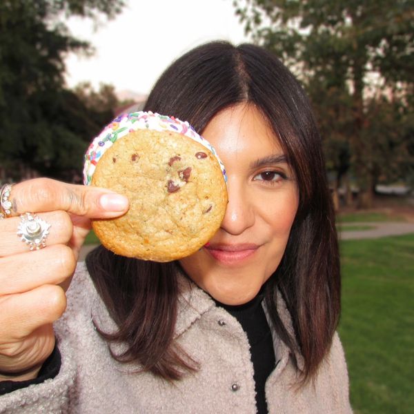young woman holding ice cream sandwich at birthday party