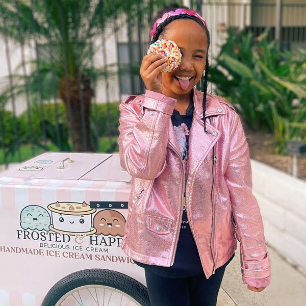 young girl holding ice cream sandwich 