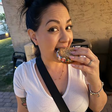 young woman eating ice cream sandwich in hand