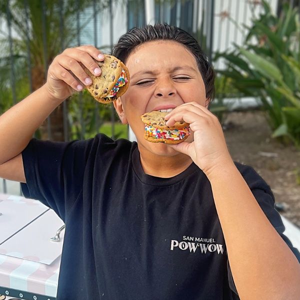 kid eating ice cream sandwiches by the pool