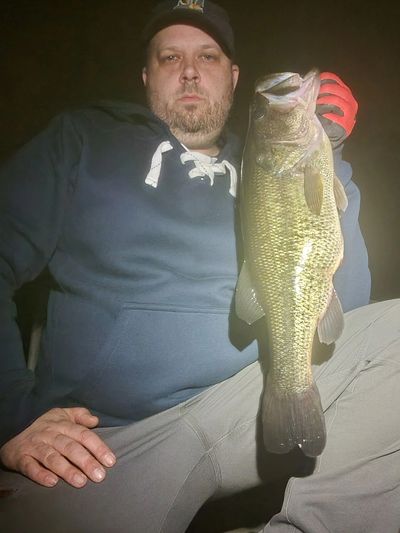 Man holding a large fish, showcasing his catch.
