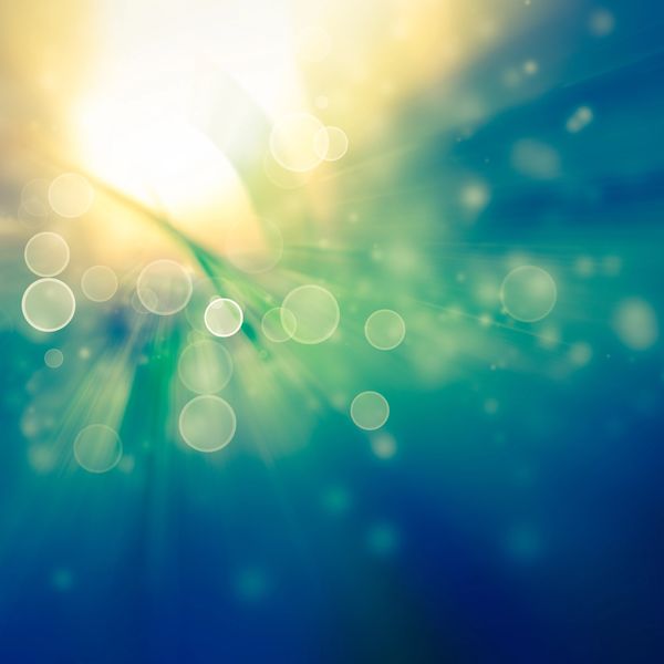 Soft abstract background, with flowing teal and gold light radiating from centre