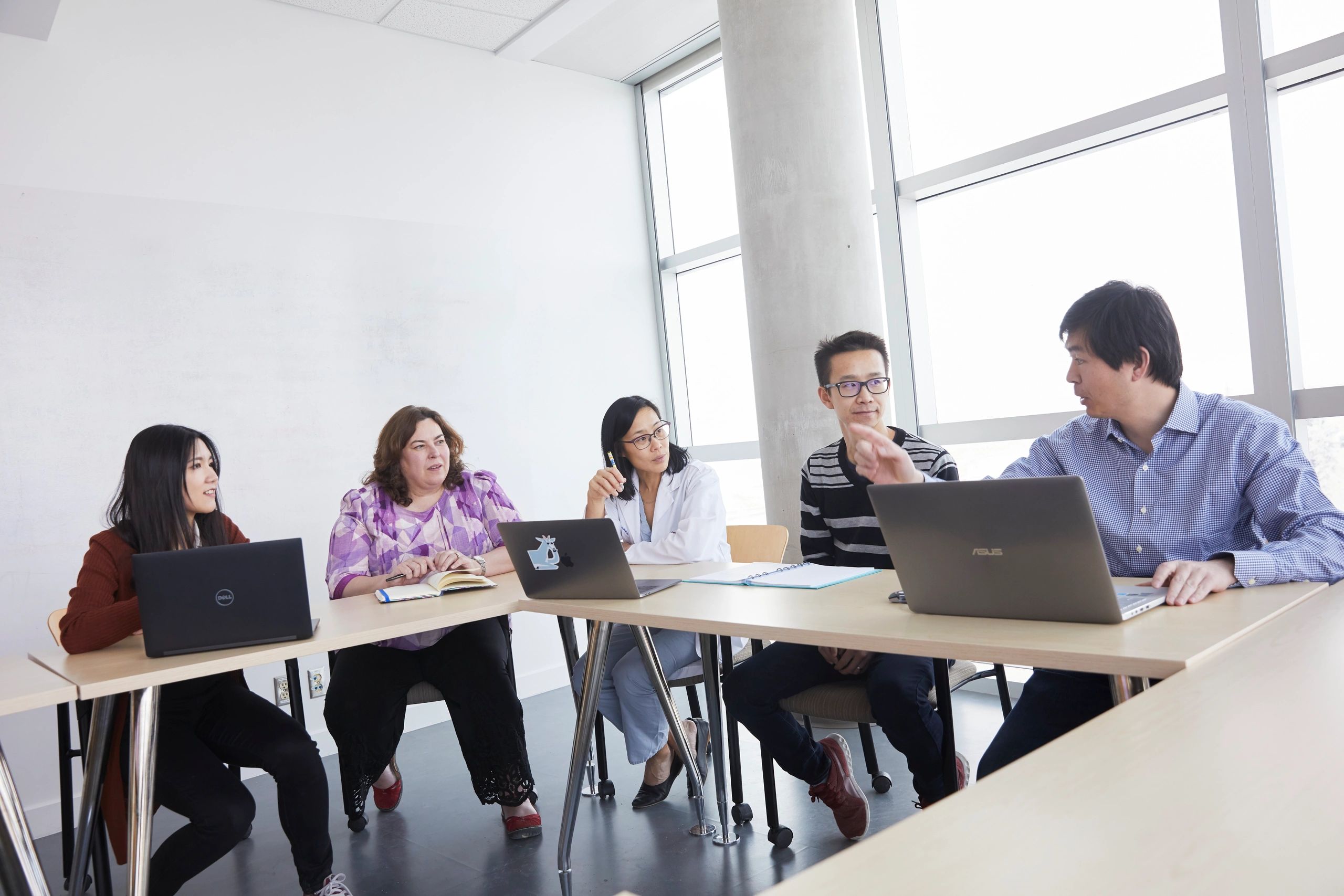 Team of researchers working in a group setting.