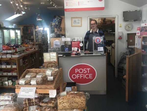 Spaxton Community Store interior with a person staying at the office