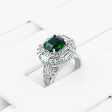 Silver ring with a green gemstone and diamond accents.