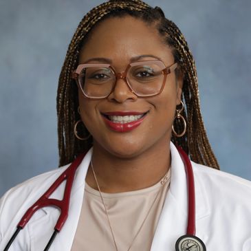 A smiling female doctor wearing glasses and a white coat with a stethoscope.