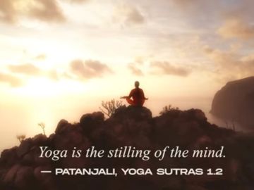 Person meditating on a rocky hill during sunrise with a yoga quote overlay.