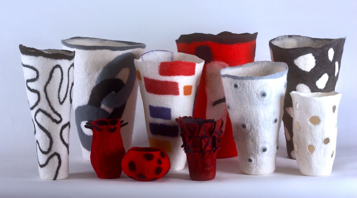 Colorful felt vases with abstract and geometric patterns.