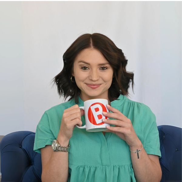 A woman wearing green Dress Hold on the cup