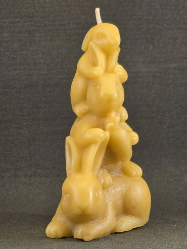 A yellow candle shaped like three stacked rabbits.