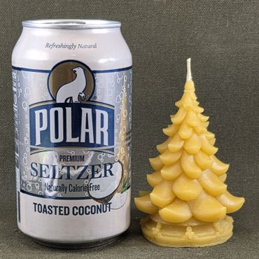 Can of Polar Seltzer next to a decorative Christmas tree candle.