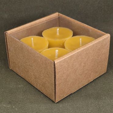 Set of four yellow tea light candles in a brown cardboard box.