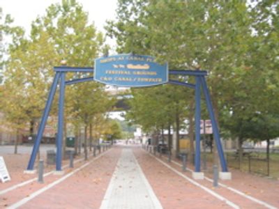 Signpost for Canal Place marks the southern terminus of the Great Allegheny Passage and the Mile 0 medallion