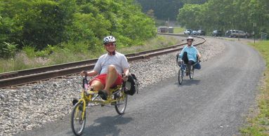 Cyclists on recumbent bikes climbing the steepest section of the GAP near Frostburg