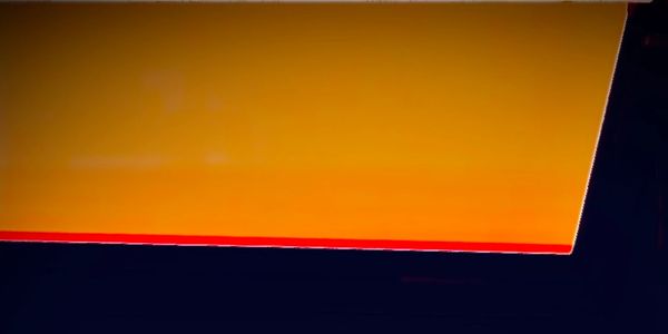 Abstract image with orange and black colors divided by a red line.