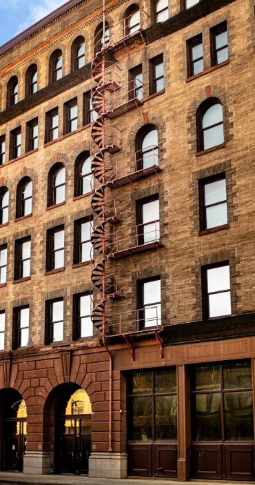 Old brick building with spiral fire escape.