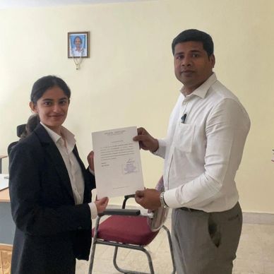 Two professionals exchanging a document in an office setting.