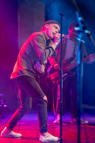 Male singer performing passionately on stage.