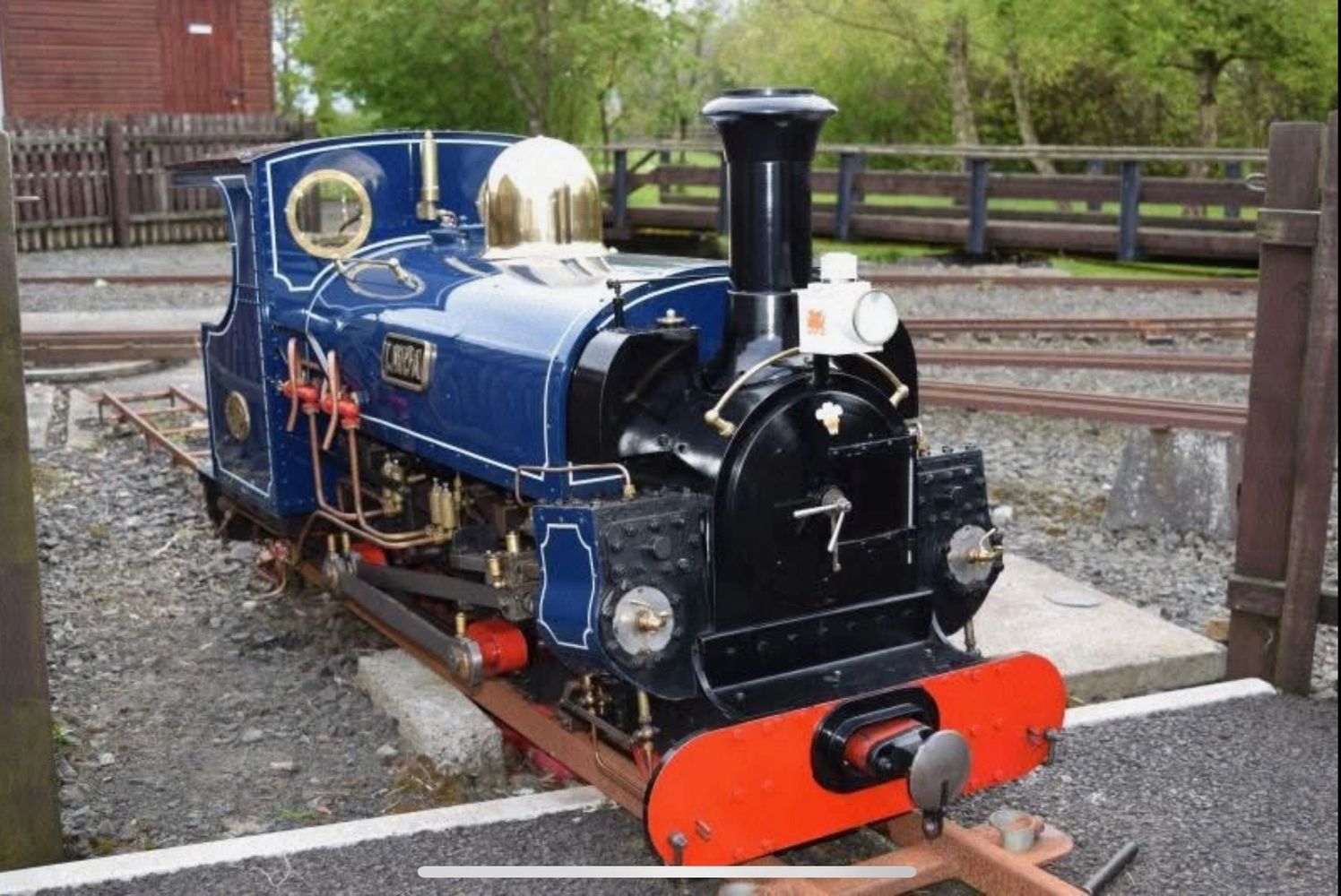 Stack of books next to pencils in a holder and a camera.