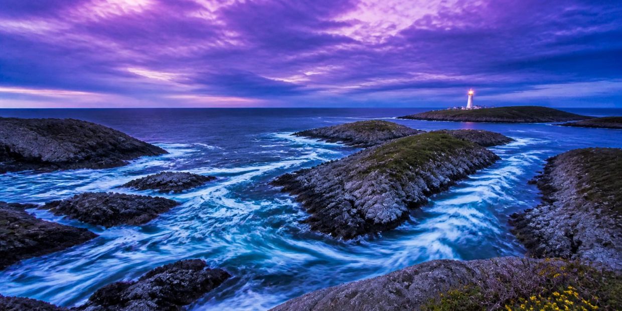 Purple-blue coastal passages with a lighthouse representing talent acquisition services.