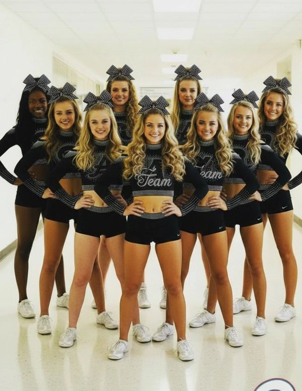Cheerleading team posing together in uniform.