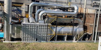 Industrial facility with large pipes and machinery.