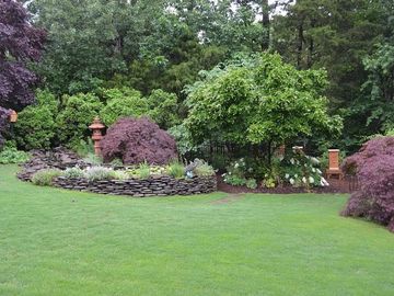 Green lawn with rock wall