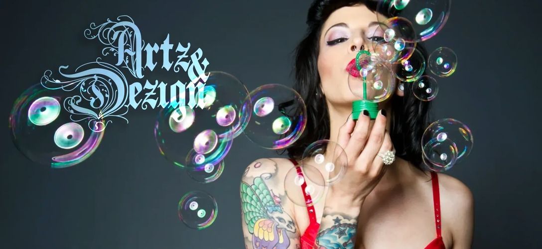Woman with a colorful tattoo blowing bubbles