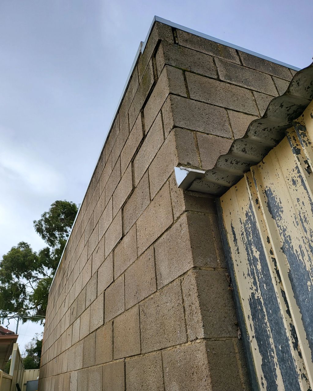 External block wall supporting roof framing. This wall has substantial differential movement.