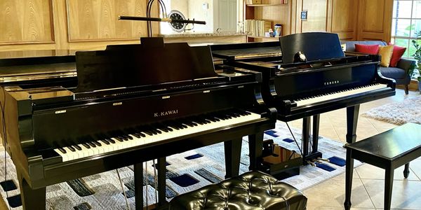 Interior of Spotlight Piano School studio in Clear Lake featuring two grand pianos.