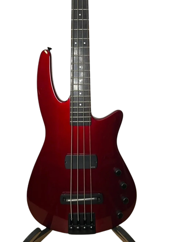 Shiny red electric bass guitar with four strings and black knobs.