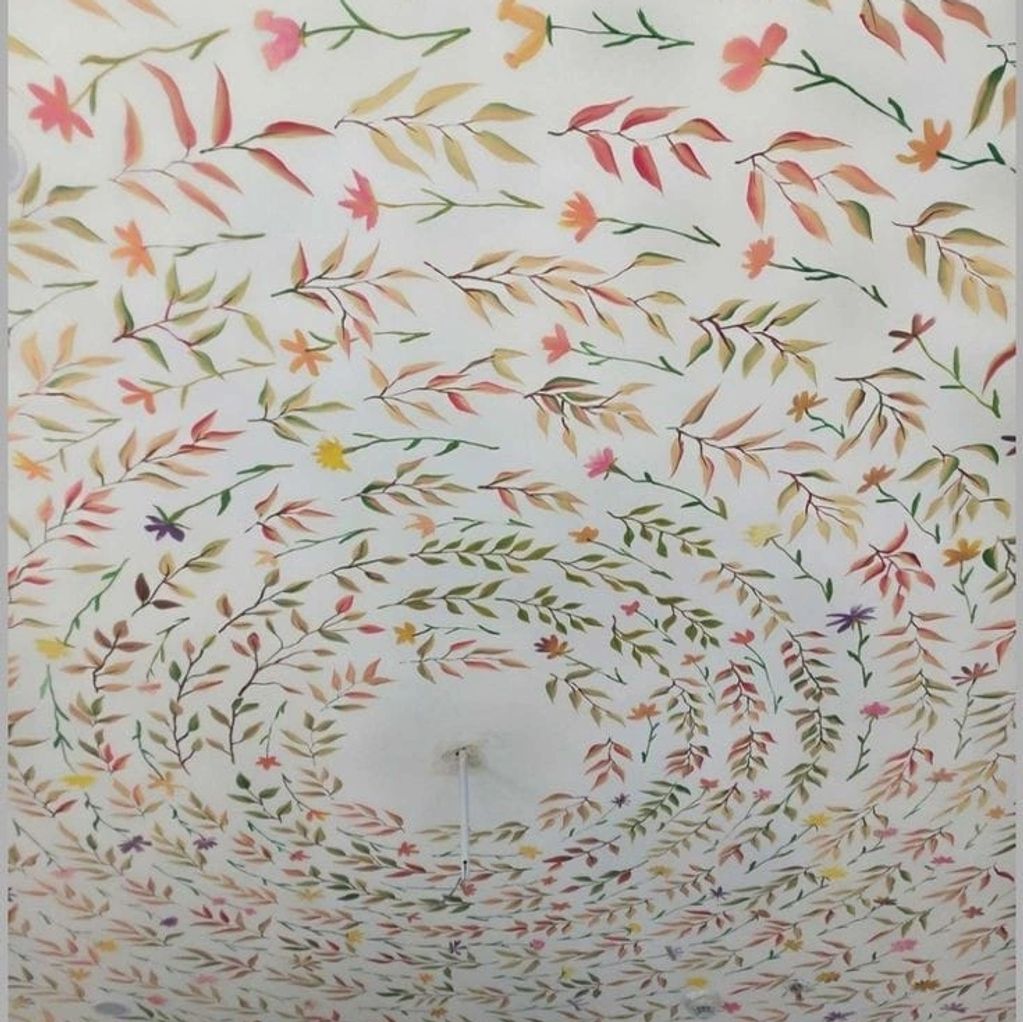 Ceiling decorated with concentric circles of colorful floral patterns.