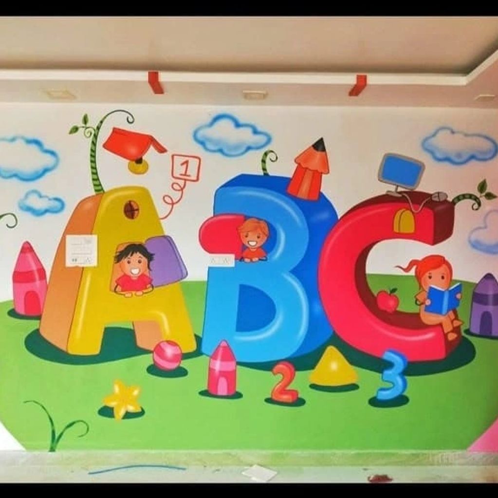 Colorful ABC letters and kids mural on a classroom wall.
