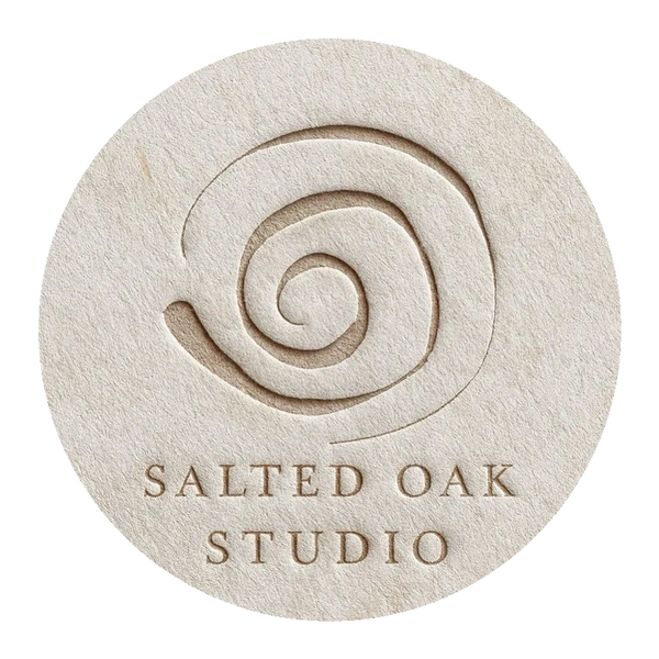 Embossed spiral logo of Salted Oak Studio on textured paper.