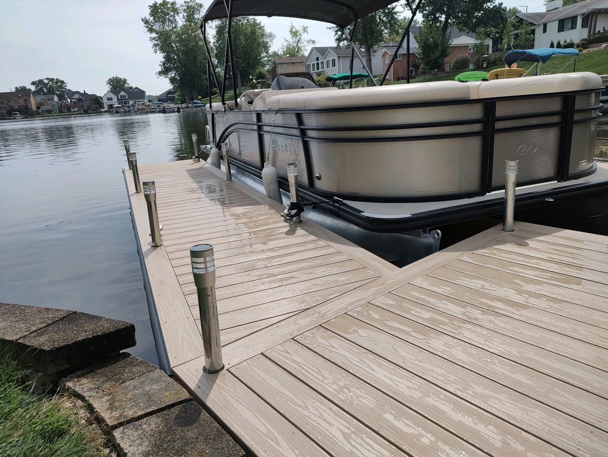 Custom-built WearDeck dock with composite decking and pontoon boat at Lake Cable, Ohio