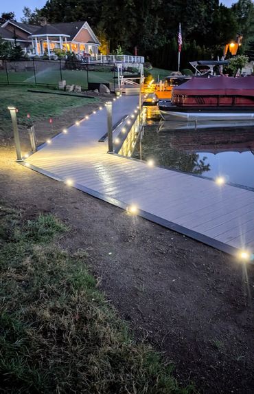 Evening view of custom WearDeck dock and boardwalk with lighting on Mud Lake, Ohio.