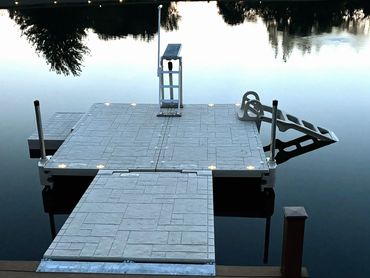 Wave Armor floating dock with solar lights installed on a private pond in Nova, Ohio.