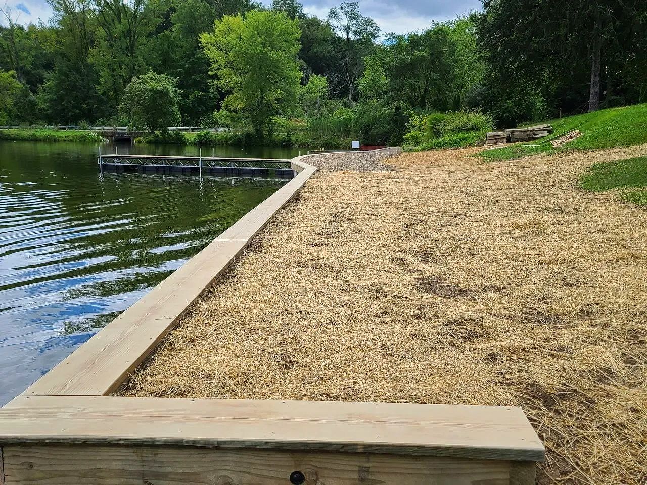 newly built seawall with dock with fresh straw and landscaping in Portage Lakes Ohio
