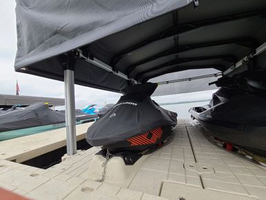 jetski's PWC's on tan floating dock with black canopy