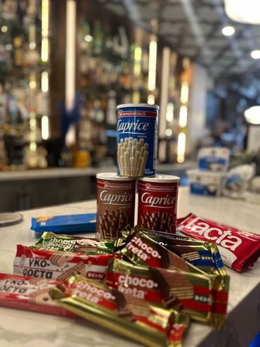 Assortment of chocolate sticks and wafers on a counter.