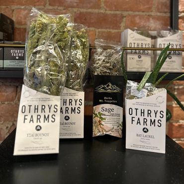Packaged herbs from Othrys Farms with various labels.
