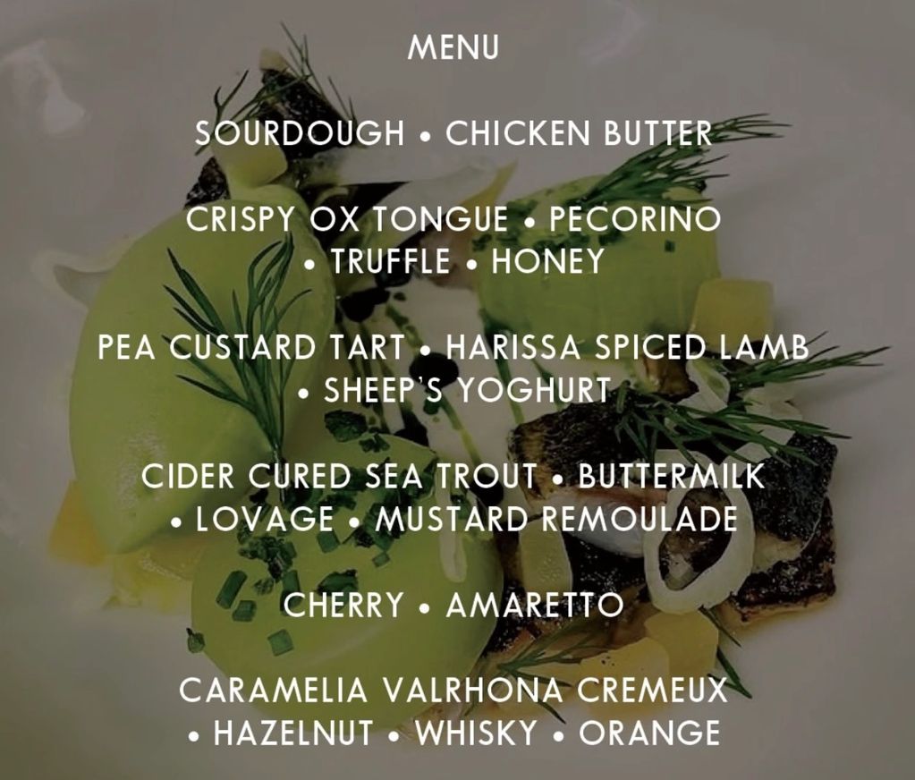 Gourmet menu with unique dishes featuring sourdough, ox tongue, lamb, sea trout, cherry, and caramelia dessert.