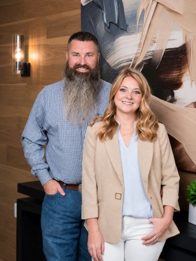 Smiling man and woman posing indoors.