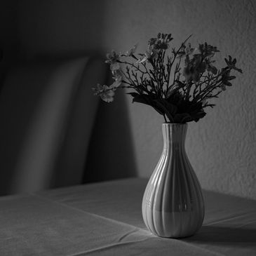 black and white photo of flowers in a vase