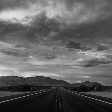 long road leading to nevada mountains across borders representing repatriation