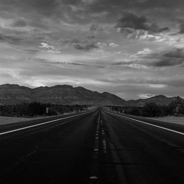 nevad road leading to mountains representing state to state transportation and repatriation