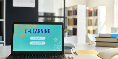 Laptop displaying an e-learning login screen in a study environment.