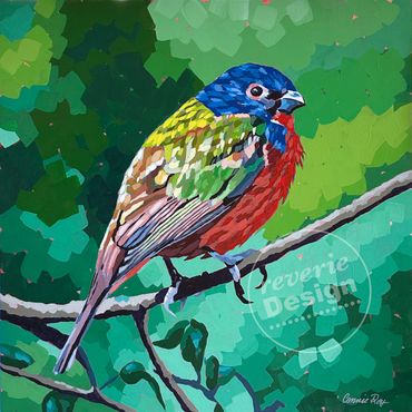 A colorful bird perched on a branch against a green leafy background.